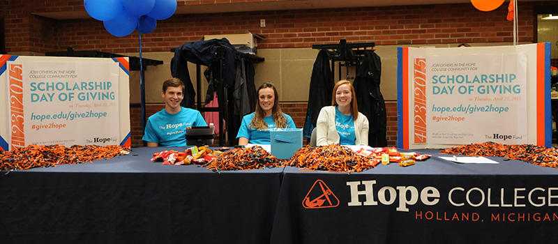 Students sitting at a Day of Giving table.