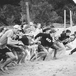 Students running on the beach