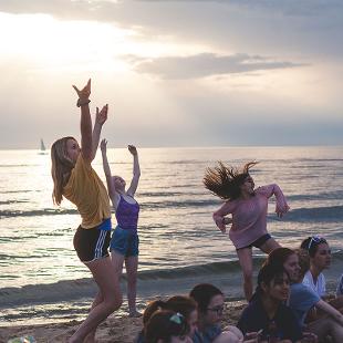 Students dancing on the beach