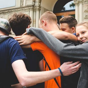 A group of Awakening students hugging each other
